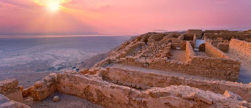 Sunrise over Masada fortress in Judean desert.