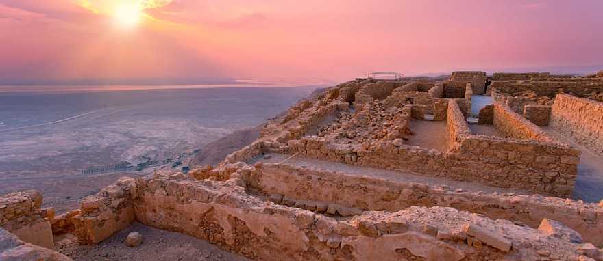 Sunrise over Masada fortress in Judean desert.