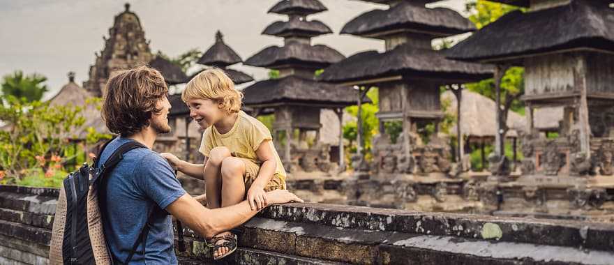 Dad and son tourists in traditional Balinese hindu temple