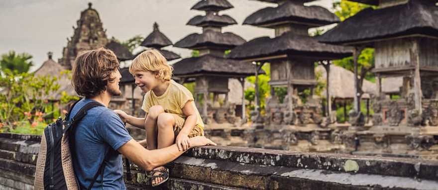 Dad and son tourists in traditional Balinese hindu temple Dad and son tourists in traditional Balinese hindu temple