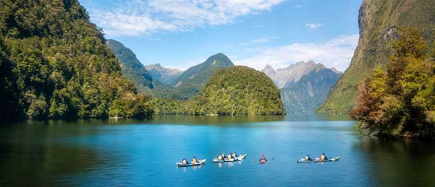 Family kayaking in the Doubtful Sound in New Zealand
