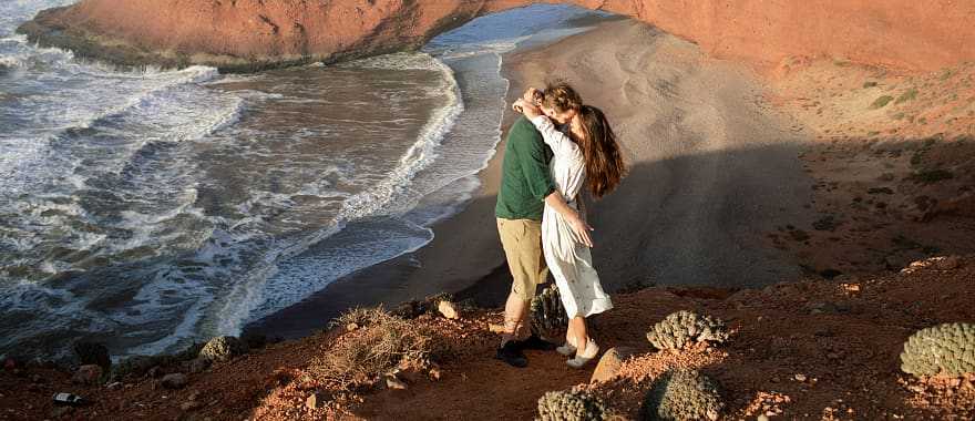 Couple at Legzira Beach near Agadir, Morocco