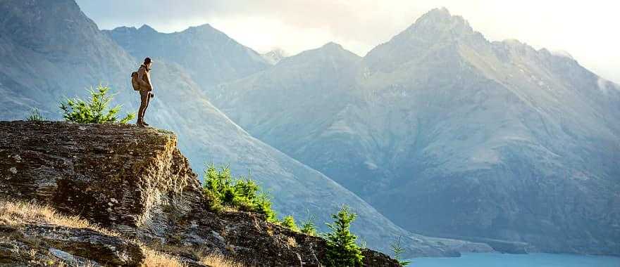 Hiker looking over lake in Queenstown, New Zealand