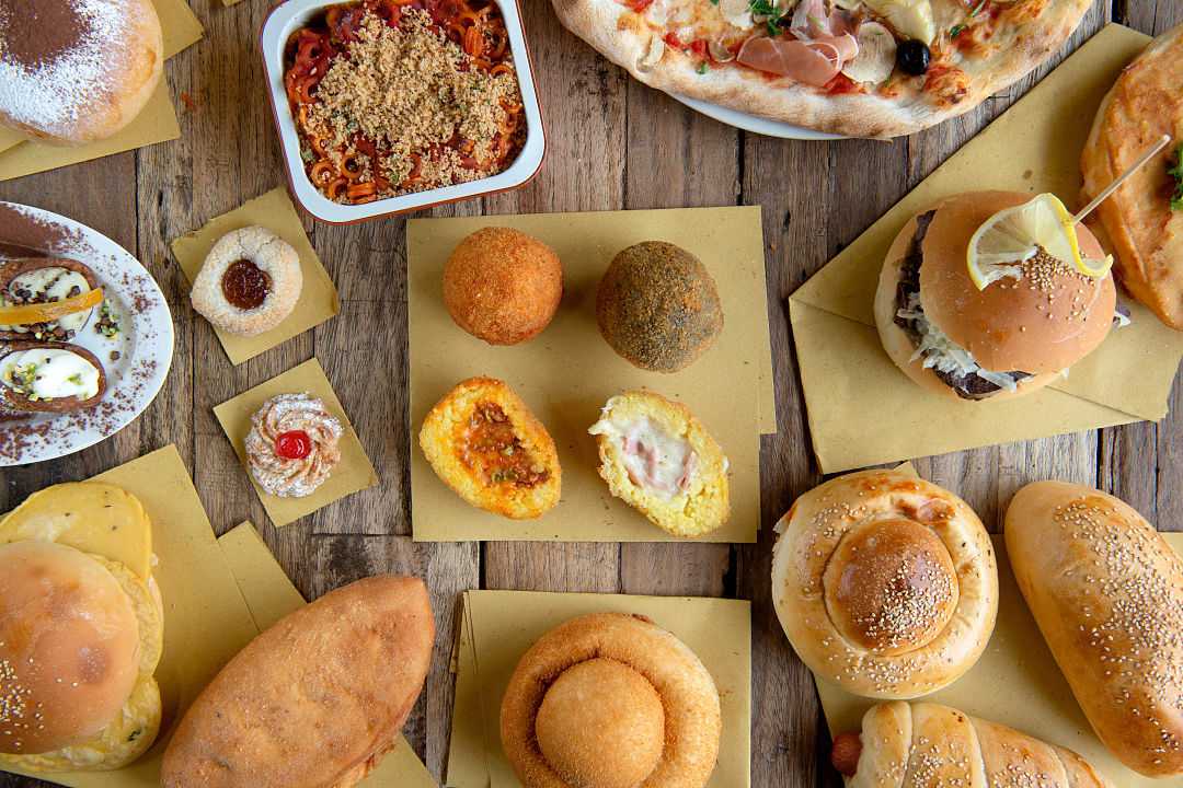 Selection of Sicilian street foods on a table in Sicily, Itlay