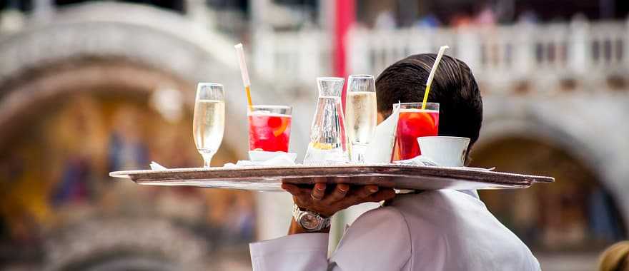 Waiter serving aperitif drinks in Venice, Italy