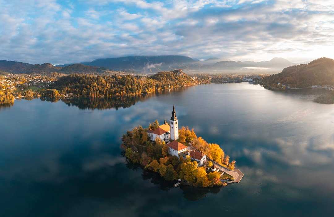 Aerial view of historic church on island lake