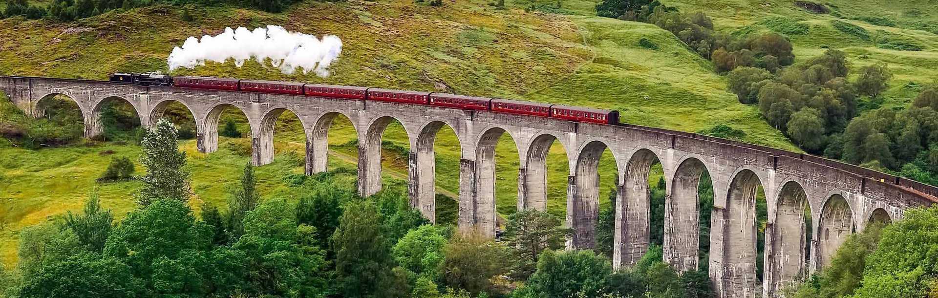 Jacobite steam train going across the Glenfinnan Viaduct in Scotland, UK