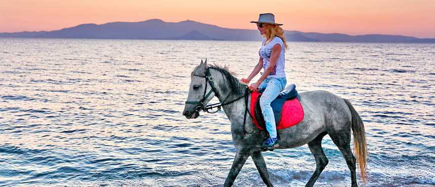Horseback riding on the beach in Greece.