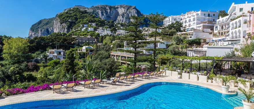 Resort pool on Carpri island with beautiful views of rocky cliffs, Italy