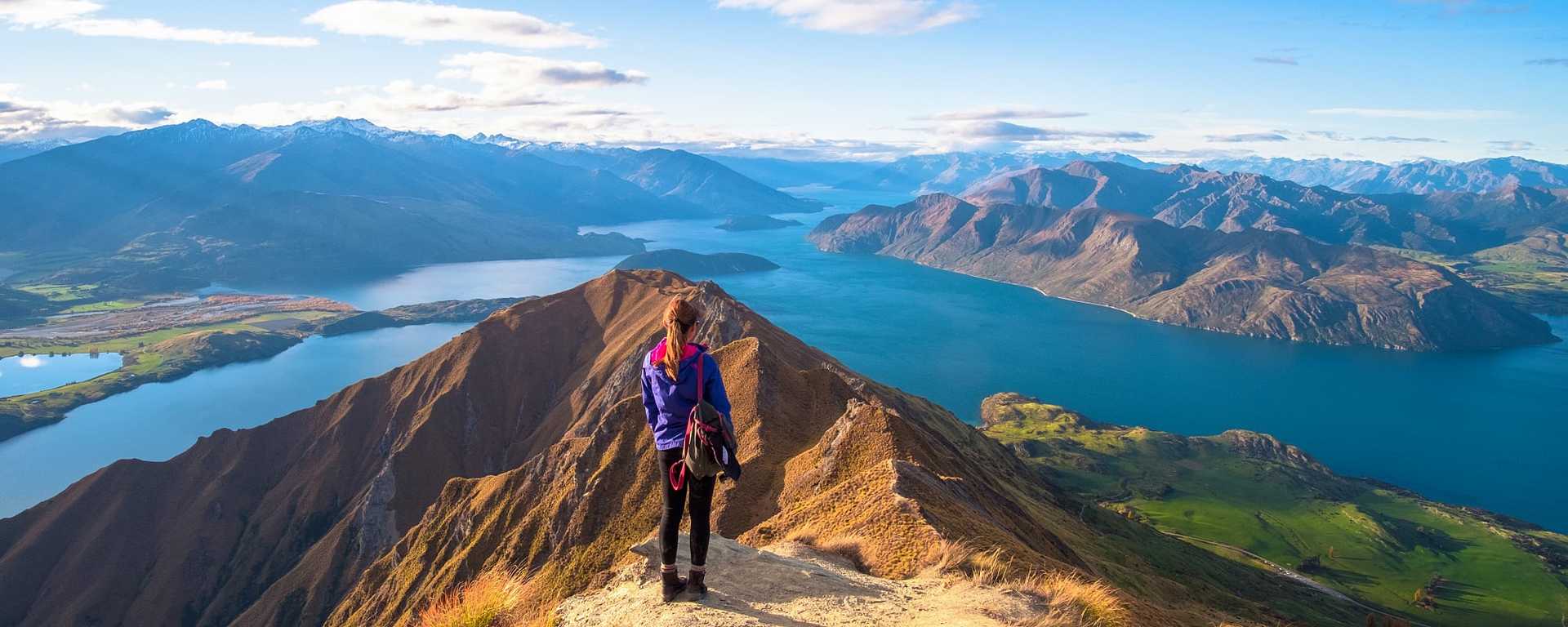 Woman hiker overlooking Lake Wanaka from Roy's Peak Track in New Zealand