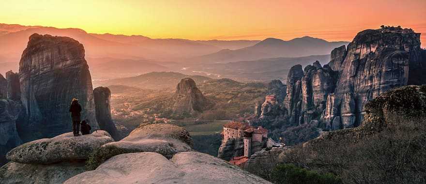 Hikers watching the sunset in Meteora, Greece