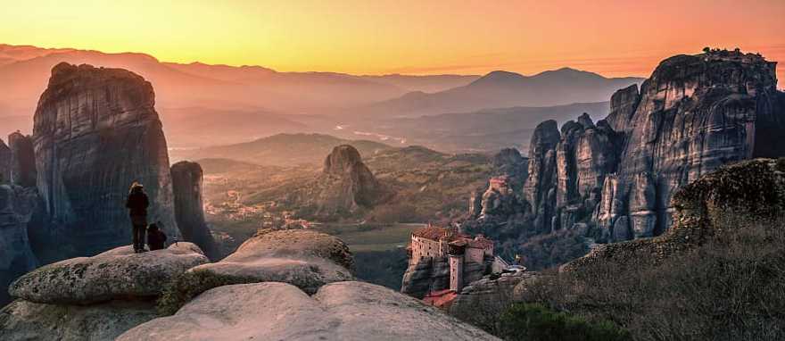 Hikers watching the sunset in Meteora, Greece