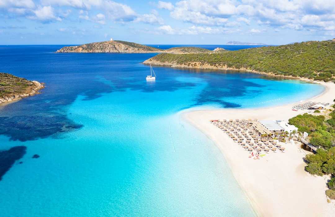 Clear blue waterof the Mediterrenean and golden sand at Tuerredda Beach in Tuerredda Beach in Sardinia, Italy