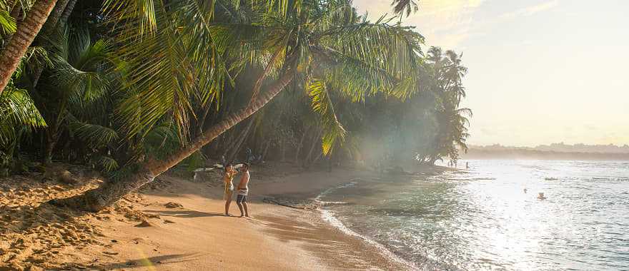 Couple at paradise beach of Manzanillo Park in Costa Rica