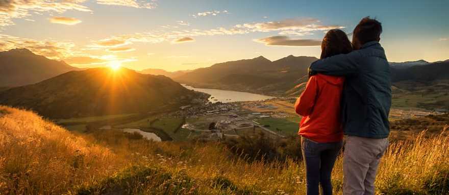 Couple enjoying a sunset in New Zealand Couple enjoying a sunset in New Zealand