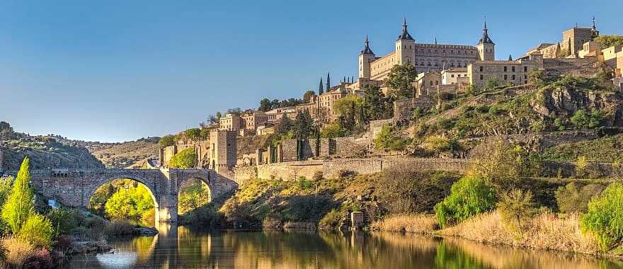 Bridge and river in Toledo, Spain with the Alcazar fortification in background
