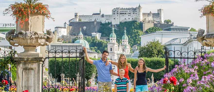 Family on vacation in Salzburg, Austria posing with Hohensalzburg in the background