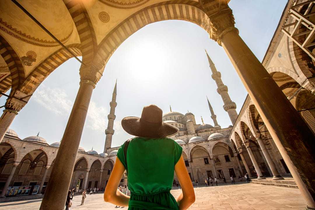 Woman visiting the Blue Mosque in Istanbul, Turkey