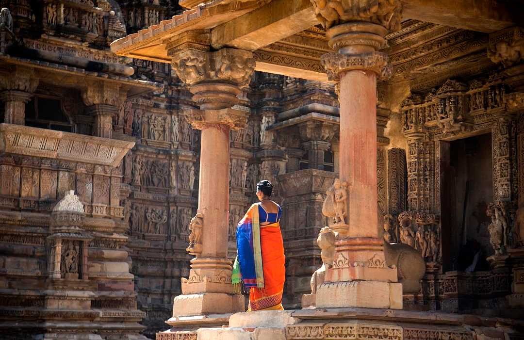 Indian women in colorful saree at Khajuraho Temple, UNESCO World Heritage Site, India. Indian women in colorful saree at Khajuraho Temple, UNESCO World Heritage Site, India.