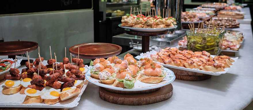 Spanish tapas, or pintxos, on the counter at a bar in San Sebastian, Spain Spanish tapas, or pintxos, on the counter at a bar in San Sebastian, Spain
