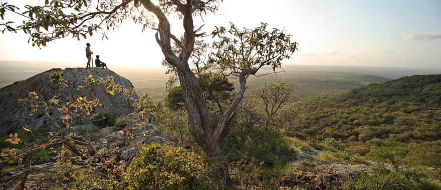 Couple viewing the vast landscape of Phinda Private Game Reserve at sunset in South Africa
