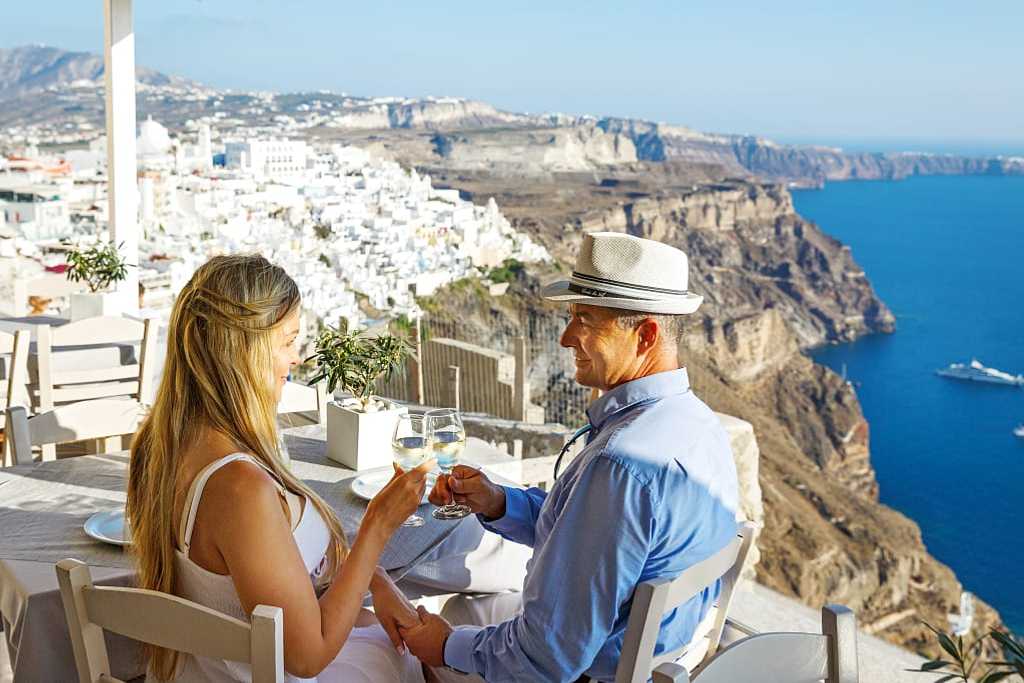 Couple enjoying some wine and the view of Santorini