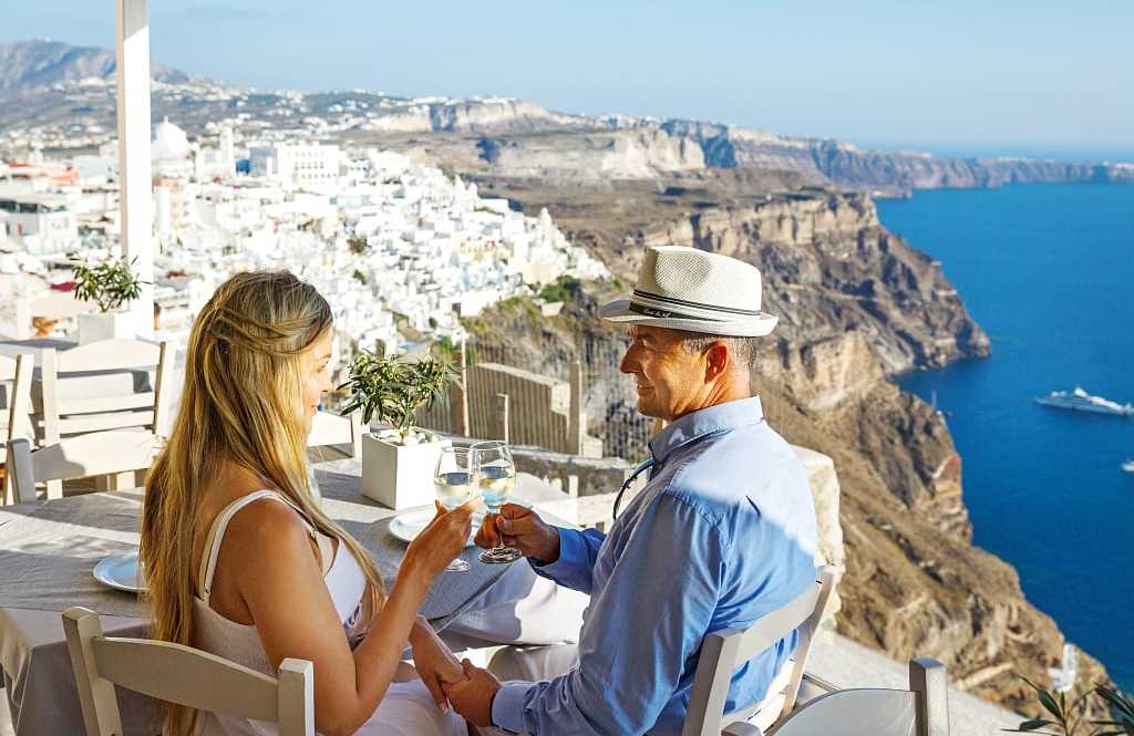 Couple enjoying some wine and the view of Santorini