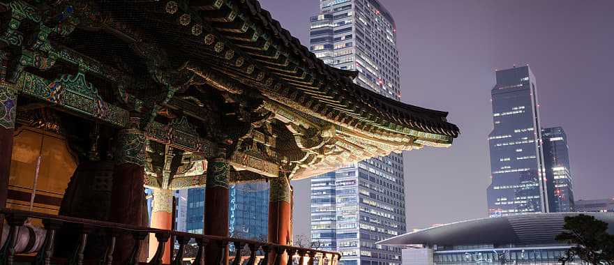 Traditional Bongeunsa Temple pavilion contrasting with the modern skyscrapers of Gangnam.