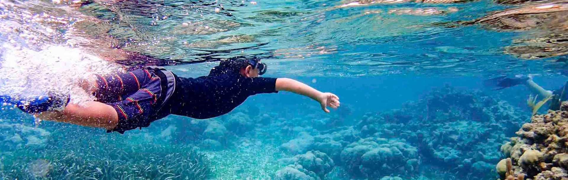 Young boy snorkeling in Ambergris Caye, Belize