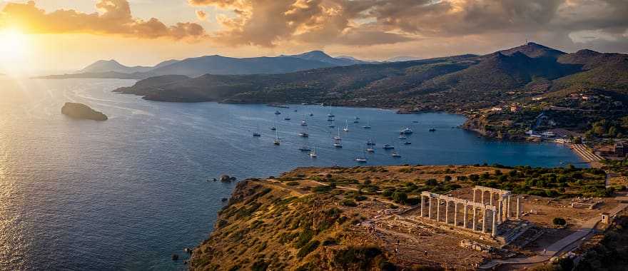 Aerial view of sunset over Cape Sounion with temple ruins in Greece