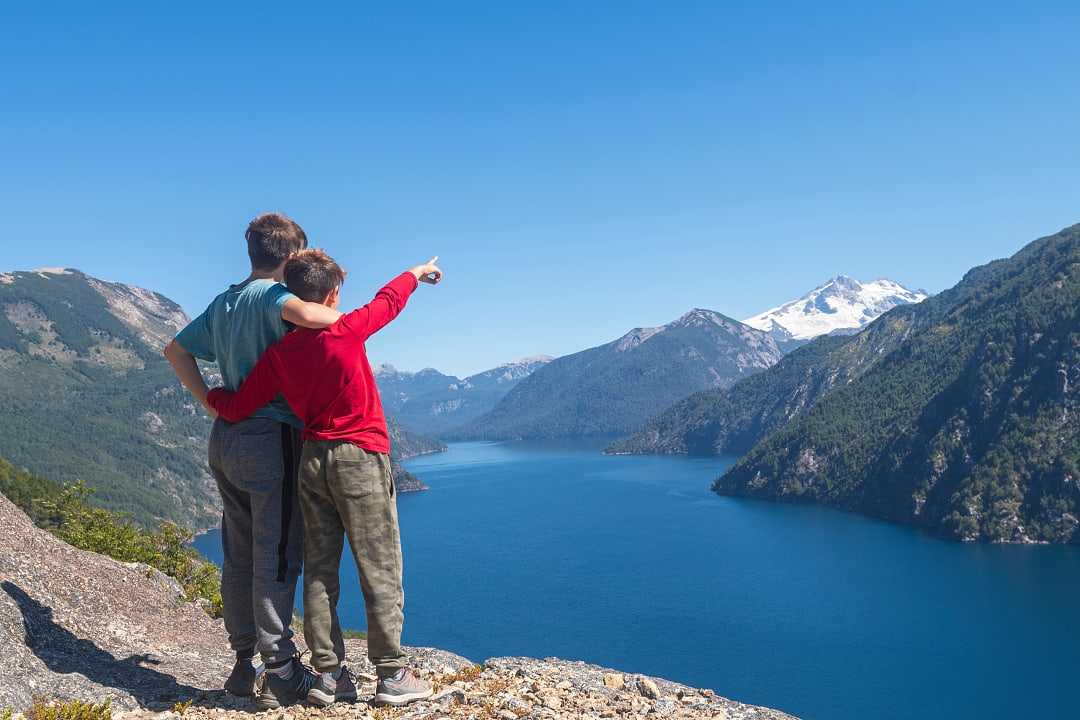 Kids enjoying the view of lake and mountains in Bariloche, Argentina