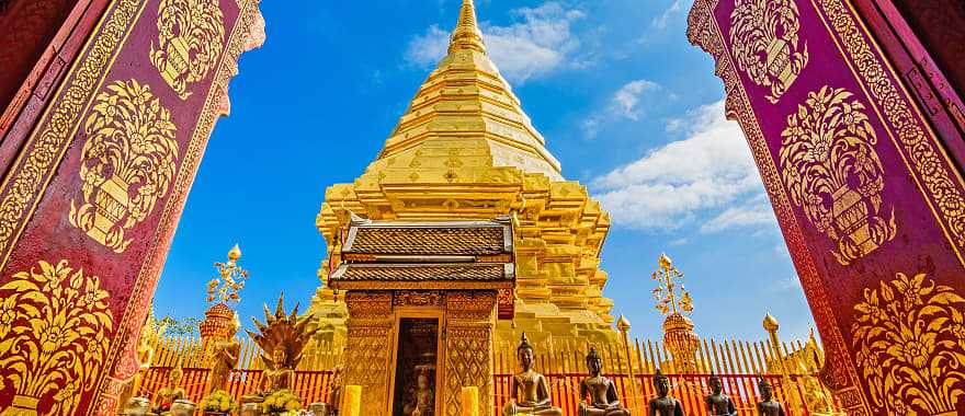 Golden temple framed by ornate archway at Wat Phra That Doi Duthep in Chiang Mai, Thailand