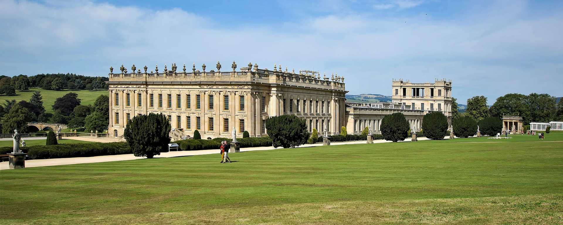 Senior couple walking the lawn at Chatsworth House in Derbyshire, England