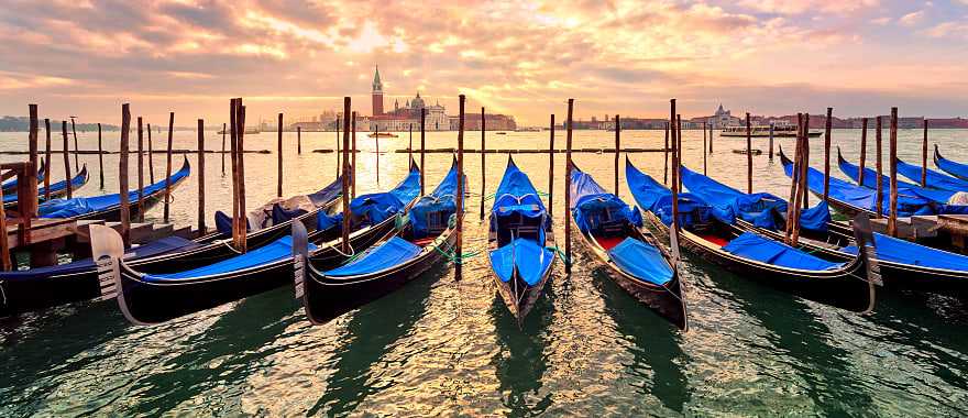 Gondolas on Venice canal at sunset