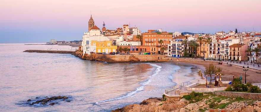 Sand beach and historical Old Town in mediterranean resort Sitges, Spain