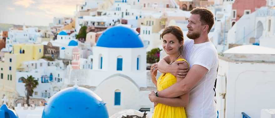 Couple enjoying the view of Santorini Island in Greece
