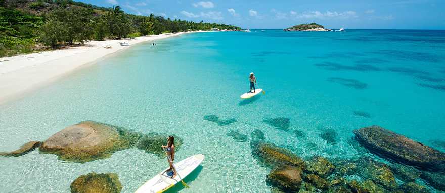 Couple paddle boarding at Lizard Island. Photo Courtesy Lizard Island Couple paddle boarding at Lizard Island