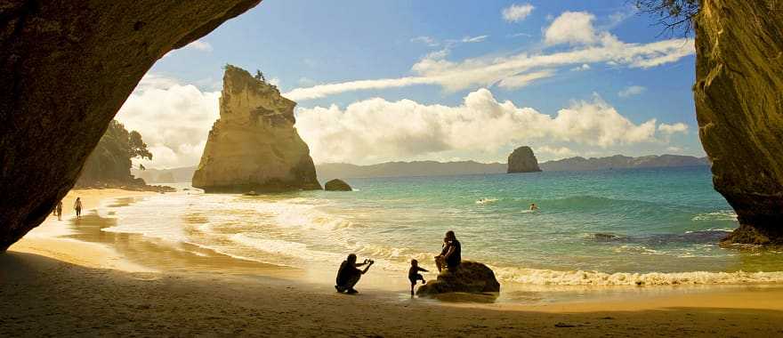 Family at Cathedral Cove in the Coromandel Peninsula, New Zealand