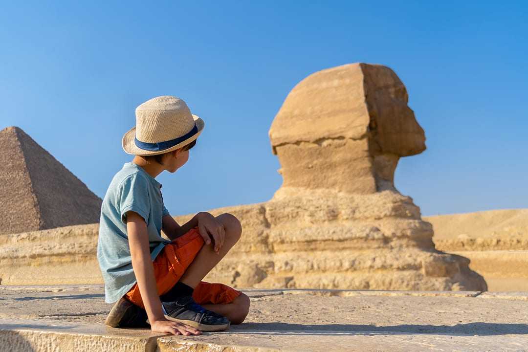 Young boy looking at the Great Sphinx of Giza in Egypt
