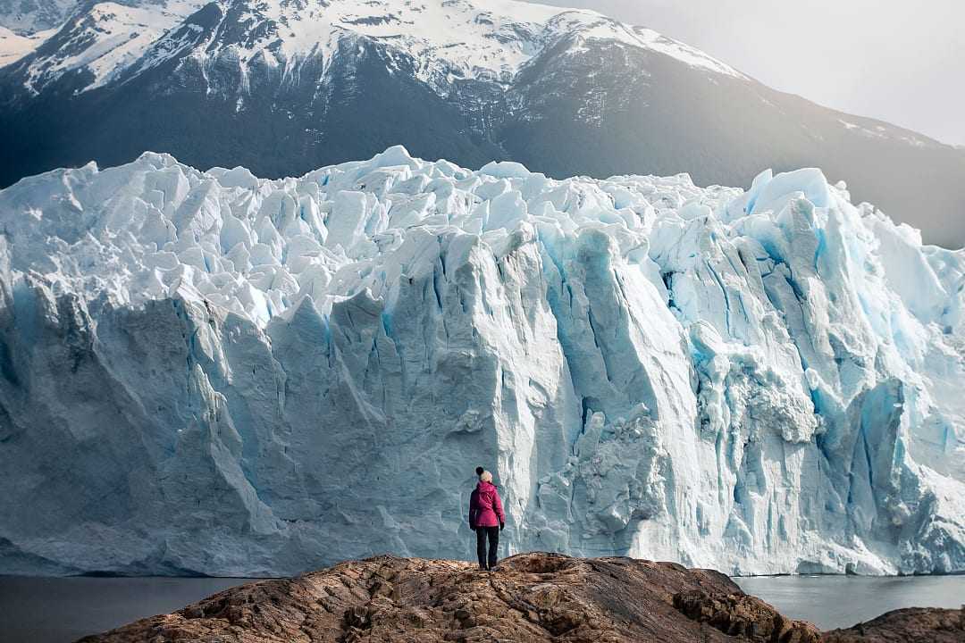 Woman standing in front of Perito Moreno Glacier in Argentina