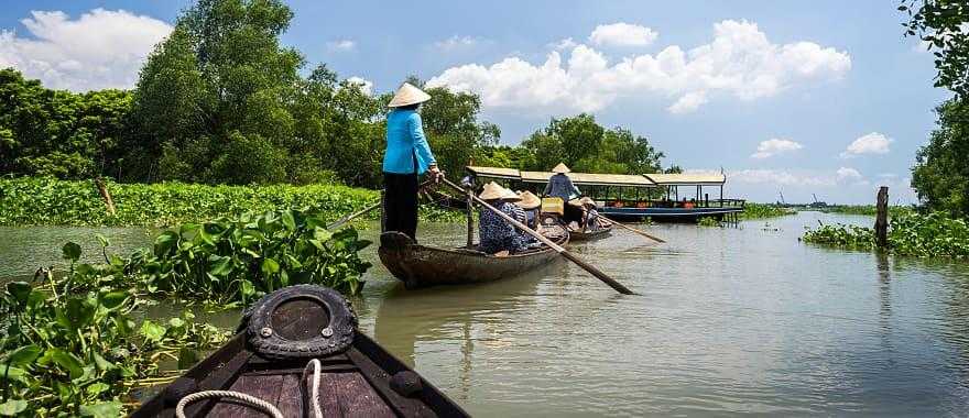 Tour row boat in Tra Su indigo plant forest in An Giang on the Mekong Delta, Vietnam.