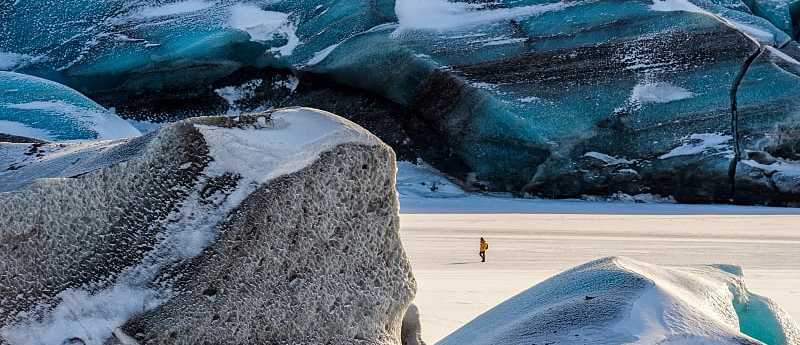 Hiker exploring Svínafellsjökull Glacier in Skaftafell Nataionall Park, Iceland