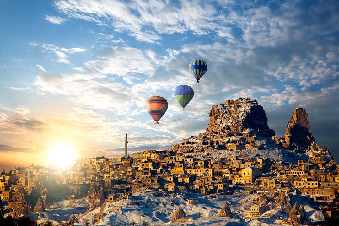 Hot air balloons flying over spectacular Cappadocia in Turkey