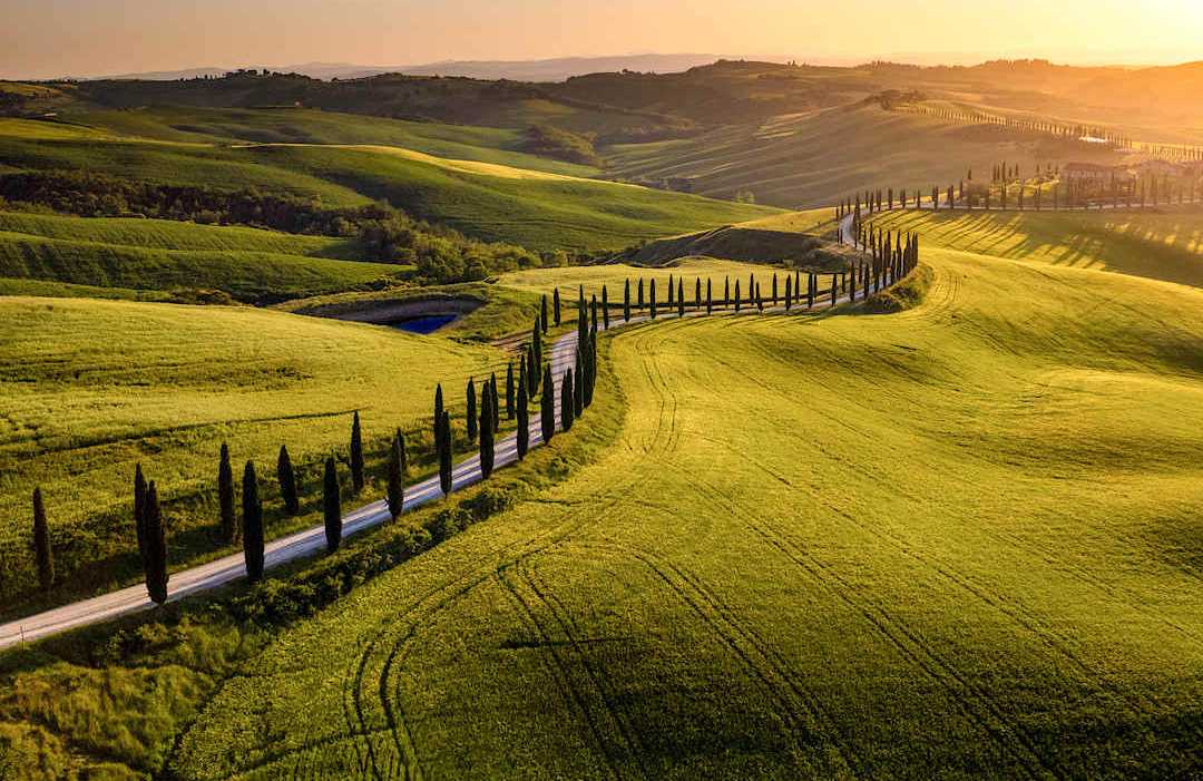 Road in Val d'Orcia at sunset, Tuscany. Road in Val d'Orcia at sunset, Tuscany.