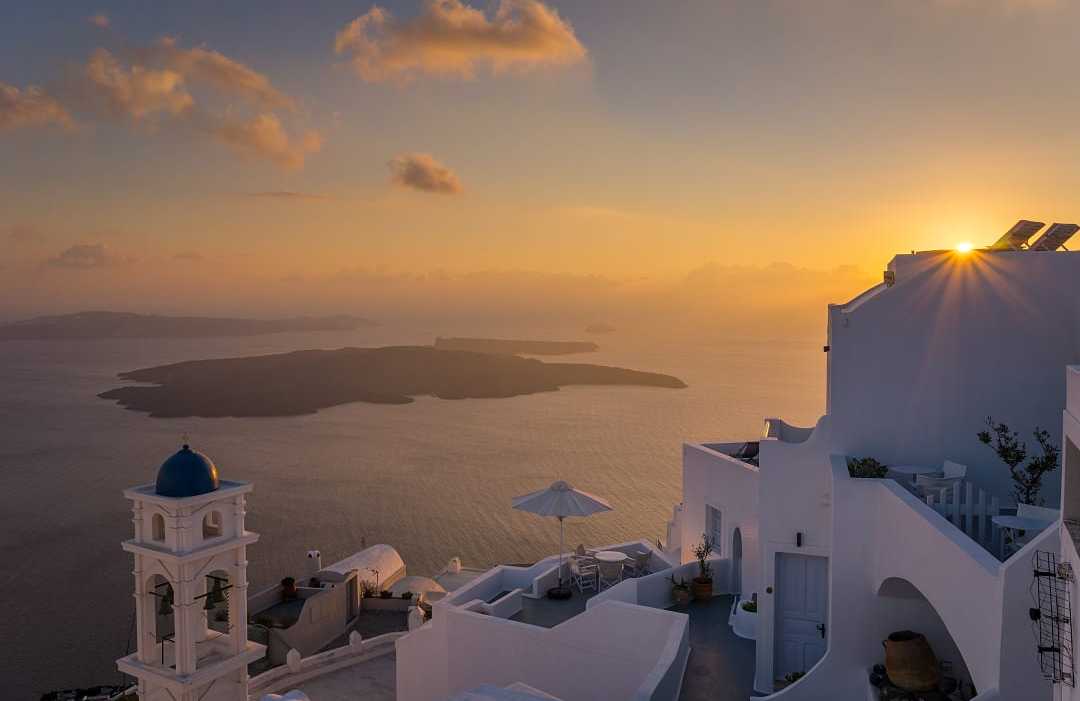 Imerovigli in Santorini, Greece Sunset over Santorini’s whitewashed paradise.