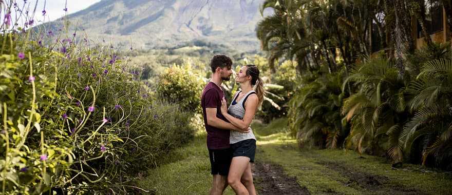 Couple with the Arenal volcano in the background in Costa Rica
