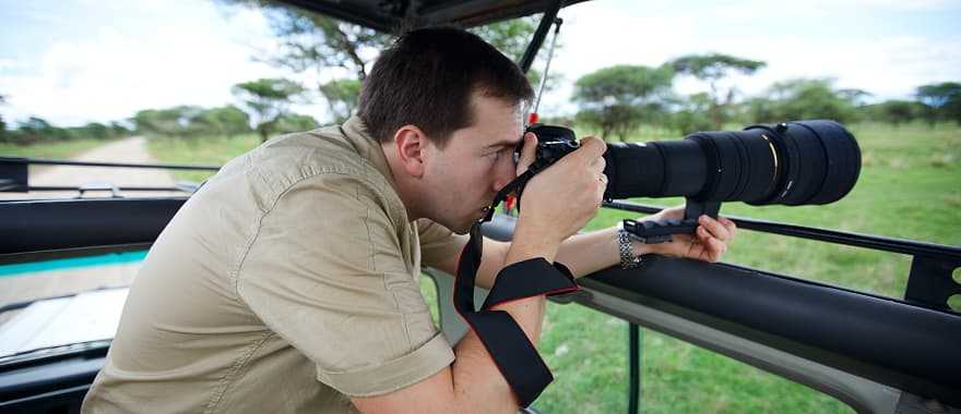 Photographer on game drive in the African savannah