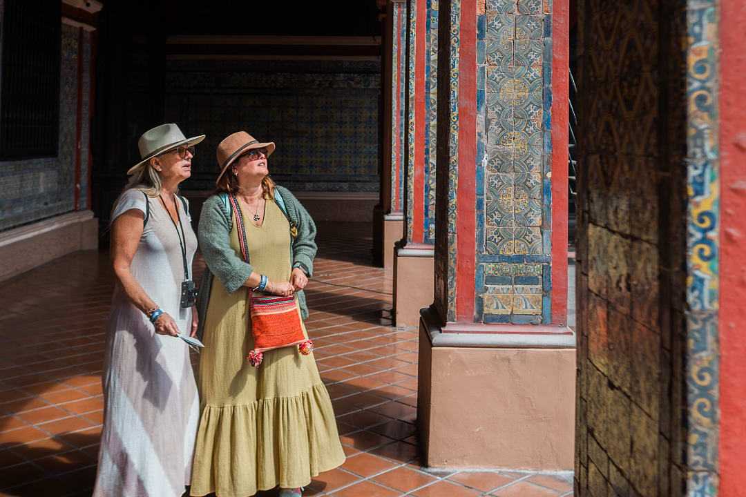 Senior travelers exploring the colorful tile work of the Convent of Santo Domingo in Lima, Peru