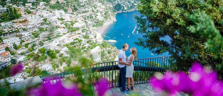 Couple enjoying a moment on the Amalfi Coast with a view of Positano in Italy