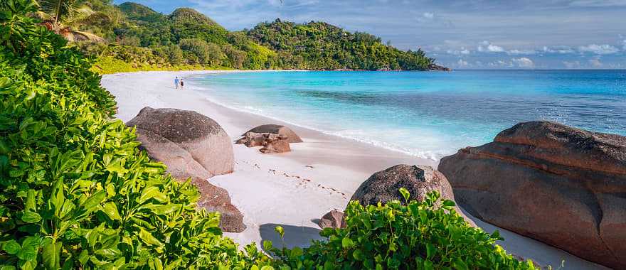 Couple on beautiful Anse Intendance beach on Mahe island, Seychelles